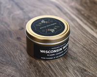 Gold Merry Christmas candle tin in Wisconsin Woods scent. Hand poured in the woods of wisconsin