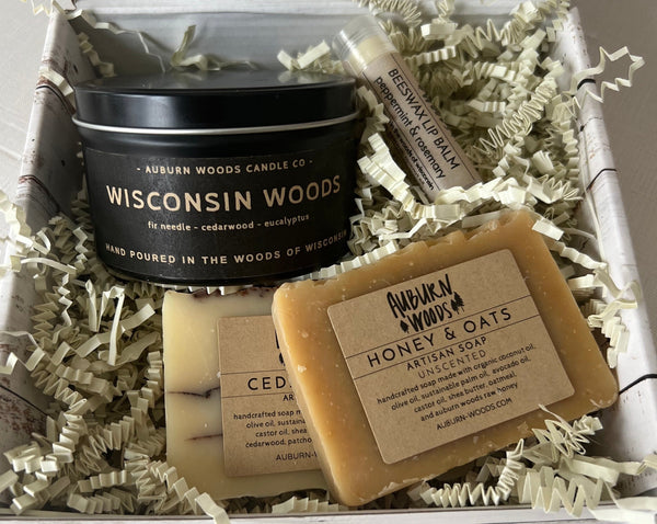 Wisconsin  Gift Set contains a Wisconsin Woods candle tin, two half bars of soap and a lip balm all tucked in a gift box. Made in Kewaskum Wisconsin. Natural Soap and Coconut Wax Candle. Reminiscent of a walk through the Wisconsin Woods