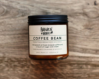 COFFEE BEAN CANDLE captures the aroma of a freshly brewed cup of coffee with a hint of sugar and cream. The wooden wick gives off a subtle crackle while the coconut wax ensures a clean, long-lasting burn. Perfect for enjoying the aroma of a coffee shop without leaving your home.  16oz Wood Wick Jar & 8oz Classic Wick Jar  Made in the Woods of Wisconsin